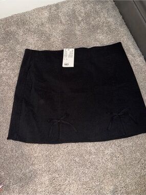 Divided Black Mini Skirt with Dual Bow Accents